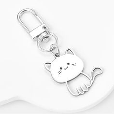 a metal key chain with a cat on it