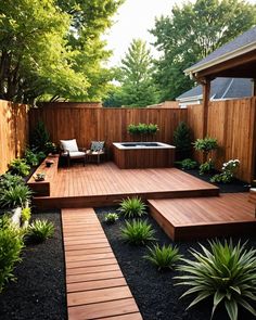 a wooden deck in the middle of a yard with steps leading up to an outdoor jacuzzi tub