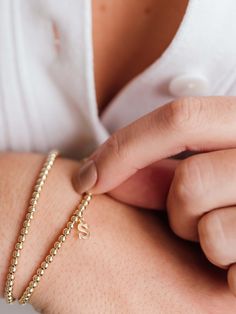 Make your stack personal with an Initial Charm! Wear your own initial, your children's, or a loved one's for a sentimental touch — or gift the heartwarming piece to someone you love. Designed with durability in mind, our gold-fill beads and charms are secured on extra-strength stretch cord to withstand your busy life and maintain their shine. Whether you dress them up, dress them down, or pile them on, you’ll truly never take them off. Adjustable Everyday Gold Bracelet For Mother's Day, Yellow Gold Bracelets For Friendship On Mother's Day, Yellow Gold Bracelets For Friendship And Mother's Day, Yellow Gold Bracelets For Mother's Day And Friendship, Personalized Adjustable Gold Bracelet For Everyday, Everyday Adjustable Personalized Gold Bracelet, Yellow Gold Bracelets For Everyday And Mother's Day, Personalized Adjustable Classic Heart Bracelet, Classic Adjustable Personalized Heart Bracelet