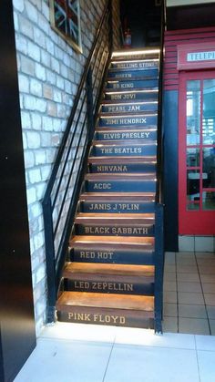 the stairs leading up to the restaurant are decorated with black and white lettering on them