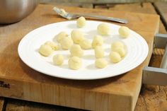 some food on a white plate sitting on a cutting board