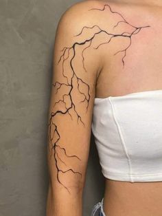 a woman's arm with a lightning tattoo on it