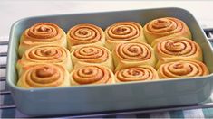 a pan filled with cinnamon rolls sitting on top of a table