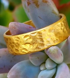 This is a thick and hefty solid 24k gold band with a hammered finish. The ring is approximately 6 MM wide. 24k gold is relatively soft, but the thickness and irregular handmade finish makes this ring wearable. This is a serious chunk of gold, and the color of real 24k gold really has no match, it is absolutely beautiful. Even if you look for one, there are not many rings available like this. The size is an 9, but I can make it any size. Also, I can make this in 22k gold, which is slightly more d Handmade Gold Wedding Bands, Handmade Recycled Gold Wedding Rings, Handmade Gold Bands As Gift, Handmade Gold Rings For Marriage, Hammered Gold Bands As A Gift, Recycled Gold Ring, Many Rings, Handmade Wedding Band, Chunky Silver Rings