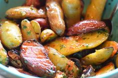 there is a bowl full of potatoes and other things in the bowl with seasoning on them