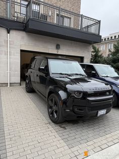 two cars parked in front of a building