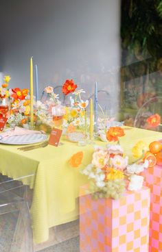 an image of a table setting with flowers and place settings on the tablecloths