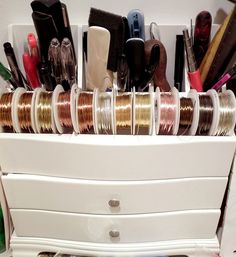 a white drawer with many different types of items in it and on top of each other