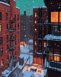 a snowy city street at night with snow falling on the ground and buildings lit up