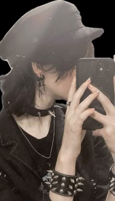 a woman with black hair and piercings taking a selfie in front of a mirror