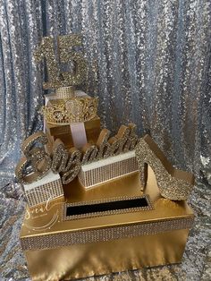 there is a gold cake that has been made to look like it's coming out of a box