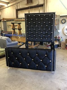 an upholstered bed in a shop with lots of furniture