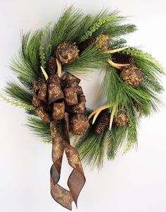 a christmas wreath with pine cones and deer antlers