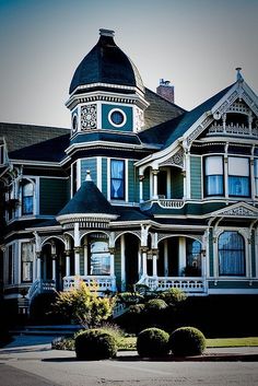 a large victorian style house with a clock on it's face