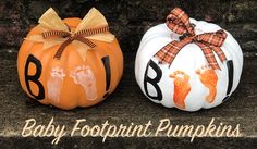 two pumpkins decorated with hand prints and bows