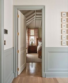 an open door leading to a bedroom with white walls