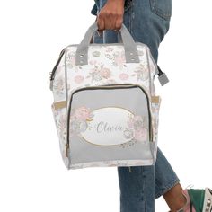 a woman carrying a white and pink floral lunch bag with personalized name on it