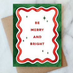 a christmas card with the words be merry and bright on it in red, green and white