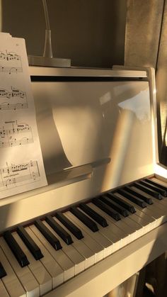 a piano with sheet music sitting on top of it