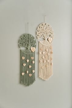 two wall hangings with hearts on them, one is made out of macrame