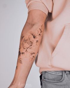 a person with a flower tattoo on their arm