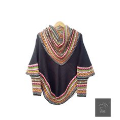 "Ponchos Sweater for Women - Alpaca Poncho for Women - Alpaca Poncho with High Neck and Sleeves - Handmade Poncho - Peruvian Poncho for Women FREE SHIPPING This beautiful alpaca poncho has an exceptional quality. They are extremely soft and wonderful to wear. It is the perfect garment to wear with jeans or pants. These luxurious ponchos have an original design, they are available in a variety of exquisite colors. Order now one of our alpaca ponchos, they have an exceptional quality! It is ideal Bohemian Black Handwoven Poncho, Black Bohemian Handwoven Poncho, Traditional Black Cape For Fall, Bohemian Knitted Winter Cape, Bohemian Knitted Cape For Winter, Folk Style Fall Poncho, Traditional Black One-size Poncho, Traditional Handmade Winter Cape, Bohemian Black Winter Wrap