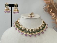 Product description- lavender high quality kundan necklace with the touch of green enamel with jhunki x tikka .  Lightweight jhumki.  . comes with matching Pair of Earrings and tikka.  Necklace width- 1.5inches  Jhumka length- 1.8 inches approximately  Tikka width- 1 inches  Style tip- Pair it with any beautiful traditional outfits  and flaunt with Unique style of collection from us. Perfect match for Festival and Traditional wear.  Take Care Tips-  Kee away from perfume, Hair spray and. Moistur Handmade Bollywood Kundan Jewelry Sets, Handmade Kundan Chandbali Necklace, Purple Kundan Bollywood Jewelry, Eid Gift Kundan Necklace With Mirror Work, Purple Kundan Jewelry For Diwali, Festive Purple Kundan Jewelry, Purple Kundan Necklace For Gifting, Purple Kundan Necklace Gift, Traditional Purple Kundan Necklace For Festivities