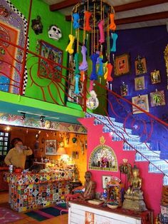 a colorful room with many items on the wall and decorations hanging from the ceiling above it