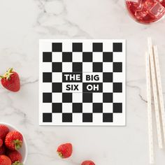 the big six oh sticker is next to strawberries and two strawberries in bowls