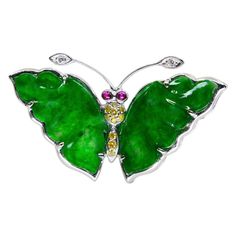 Please check out the HD video. This apple green jadeite jade butterfly is very colorful and eye catching! This is certified to be natural jadeite jade. The pendant / brooch is set in 18k white gold. The wings are made of 2 apple green carved jades. There are 2 white diamonds 0.02cts, 10 fancy yellow diamonds 0.11cts and 2 ruby eyes 0.05cts that make up this beauty. Natural un-treated apple green color jades are rare and highly sort after. This pendant can also can be used as a brooch. This fine