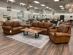 a living room filled with lots of furniture on top of a hard wood floored floor