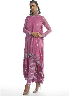 Features a deep blush asymmetrical Kurta with cutwork mirror motifs teamed with matching dhoti pants with silver gota work Composition: Kurta- Georgette, Dhoti Pants -Crepe Care: Dry Clean Only and Vacuum Storage This product can be customised for sleeves, length of blouse and neckline Delivery : 4-6 weeks as the product is hand crafted. For more information and sizes please contact fabiliciousfashion@gmail.com or visit our Copenhagen studio.About the Designer : Introducing Vvani by Vani Vats, the ultimate choice for millennial fashionistas. Experience the allure of dazzling shades, intricate embroidery, and exquisite embellishments with Vvani Vats' collection of lehengas, kurta sets and sarees. Stand out from the crowd with hand-cut mirror work and delicate pearl details that make a bold Navratri Party Straight Kurta Pant Set, Anarkali Pant Set With Mirror Work For Navratri, Traditional Drape Pant Set With Mirror Work For Eid, Eid Traditional Drape Pant Set With Mirror Work, Pink Sequined Kurta For Party, Pink Party Kurta With Sequins, Festive Party Pant Set With Gota Work, Pink Sequined Party Kurta, Bollywood Pant Set With Mirror Work For Navratri