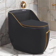 a black toilet with gold trim in a bathroom