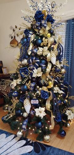 a christmas tree with blue and gold decorations