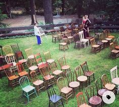 two people standing in the middle of a circle of chairs