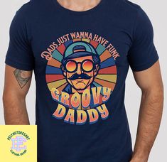 Product details: ✔️ NAME: One Groovy Daddy T-Shirt, Retro Dad Shirt, Dad Vintage Shirt, Fathers Day Shirt, Funny Dad Shirt, Gift For Daddy, Dad Birthday Gift Shirt ✔️ IMPORTANT NOTE: Both Men and Women can we our shirts because this is unisex style t-shirts;  Wash item inside out in cold water, do not bleach, do not dry clean, do not iron directly on the design. ✔️ MATERIAL: 5.3-ounce, 100% cotton (99/1 cotton/poly (Ash) & 90/10 cotton/poly (Sport Grey); Heavyweight classic unisex tee; Taped neck and shoulders; Tearaway label; Decoration type: Digital Print ✔️ OUR DESIGN PRODUCTS: Each One are designed and sold in limited quantities. The designs are created by our incredibly talented in house graphic art team who often hand draw and illustrate each Tee shirt design. ✔️ SIZE CHART: Please r Retro Letter Print Tops For Father's Day, Fun Father's Day T-shirt With Graphic Print, Pop Shirts Grandpa, Retro Graphic Print T-shirt For Father's Day, Fun Graphic Print T-shirt For Father's Day, Papa Shirt, Papa T Shirt, Father's Day Novelty Graphic T-shirt, Papa Shirts