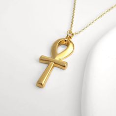 An elegant 24k gold plated ankh charm necklace. The perfect gift  for anyone who loves Ancient Egyptian mysteries.  The ankh represents the key of life and brings good fortune.  Every order comes in beautiful packaging with a free gift box included. All packaging, including gift boxes are eco friendly. SIZE: Choose from either 16, 18 or 20 inch gold plated chain and 2 inch extender (at no extra cost). MATERIALS: 24K gold plated brass, DELIVERY: All orders are despatched within 2 days. UK - FREE Gold Ankh Jewelry For Gifts, Spiritual Ankh Necklace For Gift, Gold Ankh Necklace For Gift, Handmade Gold Ankh Necklace, Handmade Ankh Gold Necklace, Gold Ankh Necklace Gift, Gold Cross Amulet Necklace, Yellow Gold Ankh Necklace, Gold Ankh Amulet Jewelry