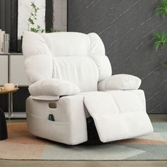 a white recliner chair sitting on top of a rug