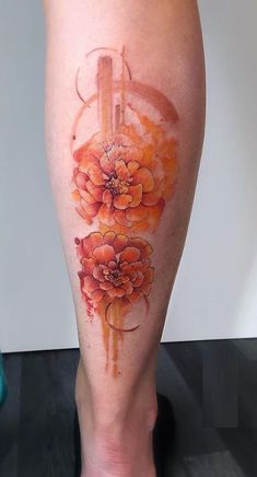 a woman's leg with flowers painted on it and an arrow in the middle