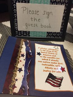 a sign that says please sign the guest book with an american flag and stars on it