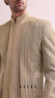 Exude sophistication and style with our regal beige sherwani set. A stunning juxtaposition of modernity and traditions.
the double layered raw silk sherwani is elevated with intricate cutdana.
and hand embellished zardozi work. Paired with a complementing kurta and pants. Kurta And Pants, Embroidery Designs Free Download, Zardozi Work, Groom Looks, Free Embroidery Designs, Free Embroidery, Kurta Set