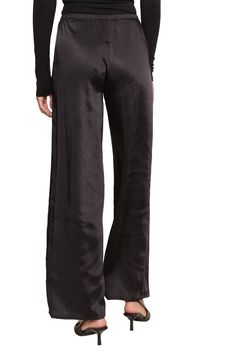 The Silk Dreams Pants are a chic and versatile addition to any wardrobe, crafted from smooth black satin fabric that offers a luxurious feel and elegant drape. With a comfortable elastic waistband and wide-leg silhouette, these pants provide both style and ease, making them perfect for dressing up or down. Whether paired with a simple blouse or a statement top, these pants elevate any outfit with effortless sophistication. Fall Knits, Black Satin Fabric, Business Chic, Elegant Drapes, Simple Blouse, Jumpsuit Jacket, Knitting Accessories, Hat Hairstyles, Black Satin