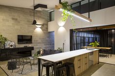 a living room filled with furniture and a flat screen tv mounted to the side of a wall