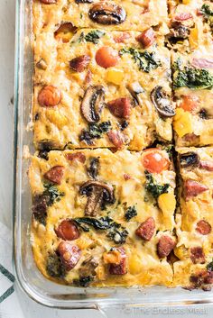 a casserole dish with sausage, mushrooms and spinach