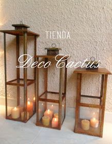 three wooden lanterns with lit candles in them and the words tendia deco lacis