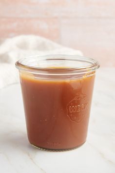 a jar filled with sauce sitting on top of a table