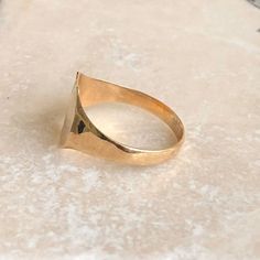 A vintage 9 carat gold signet ring with a engraved detailing in the corner. This charming piece has a great shape and a small amount of detailing on the corner of the face.CONDITION: Wear consistent with age and use. Please see photos for more detail.ASSAYED IN BIRMINGHAM, MADE CIRCA.1987APPROX. BAND WIDTH (SMALLEST): 2.5mmAPPROX. FACE SIZE: 12mm x 11mmRING SIZE: UK: R | US: 8 1/2WEIGHT: 2.1g Vintage 14k Gold Open Signet Ring, Antique Gold Open Signet Ring, Vintage Yellow Gold Open Initial Ring, Vintage Hallmarked Initial Open Ring, Gold Victorian Signet Ring For Promise, Antique Gold Signet Ring For Promise, Gold Victorian Style Signet Promise Ring, Gold Antique Signet Ring For Promise, Classic Hallmarked Heart Ring For Formal Occasions