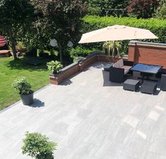 an outdoor patio with table, chairs and umbrella