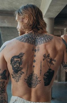 a man with long hair and tattoos on his back