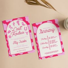 two pink and white wedding stationery cards on top of a table with a plant in the background